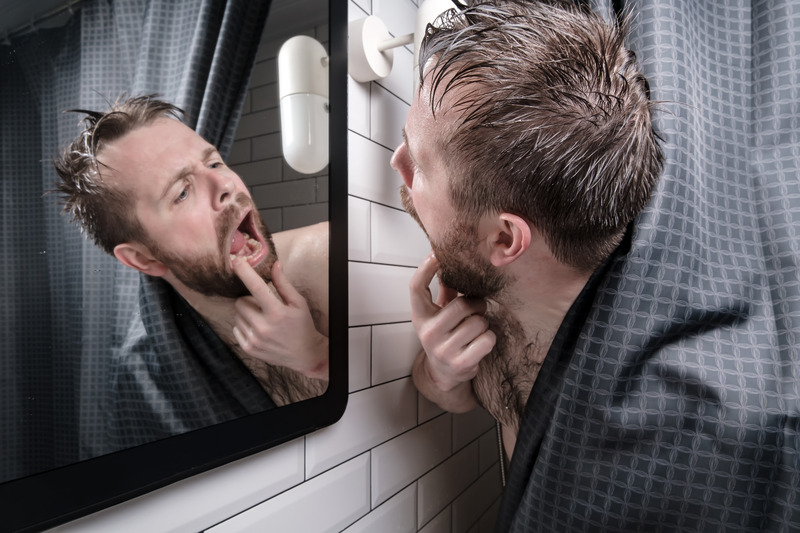 Patient checking their mouth for gum bumps